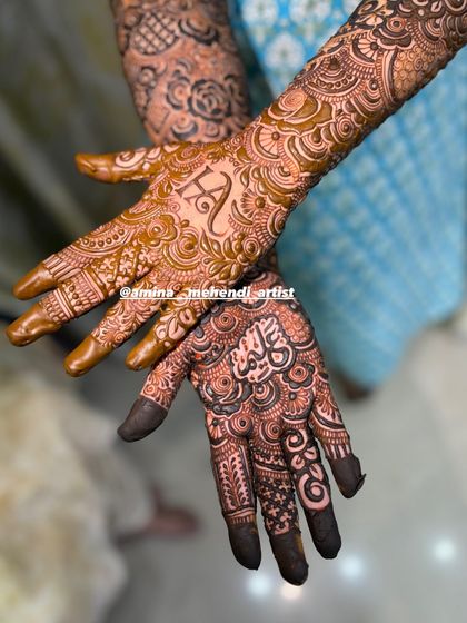A beautiful close-up showing the initial 'H' on one palm and a name in Arabic script on the other.