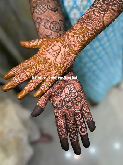 A beautiful close-up showing the initial 'H' on one palm and a name in Arabic script on the other.