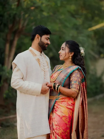 The couple shares a sweet, knowing look. This photo captures the love and understanding between them during their traditional Maharashtrian engagement shoot.