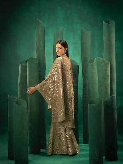 A three-quarter back view of the 29 India cape set, showing how the garment drapes and flows.