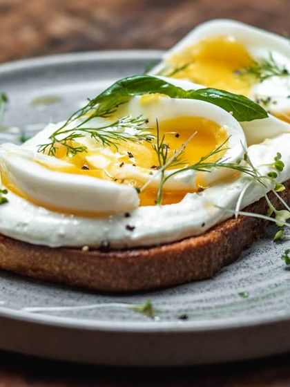 Our version of Turkish eggs on toast. Perfectly soft-boiled eggs sit on a bed of garlicky yogurt spread over our toasted sourdough, finished with dill and chili oil.