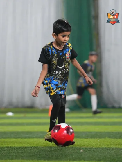 A player works on his ball control with a red ball, a drill designed to improve touch and precision.