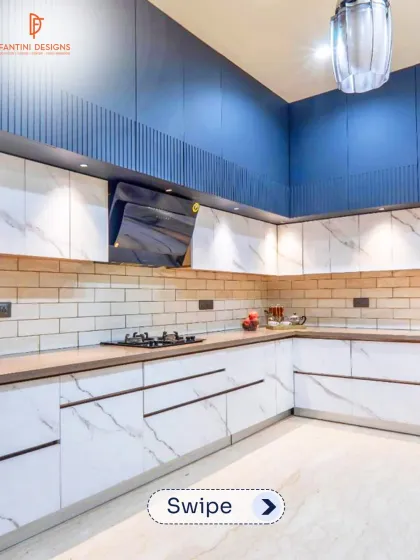 This L-shaped kitchen combines white marble-patterned cabinets with a bold blue accent wall and a subway tile backsplash, creating a fresh and modern look.