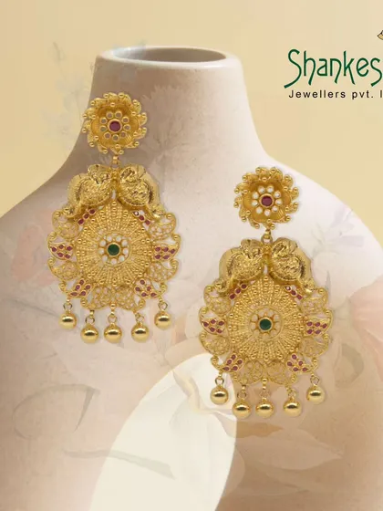 Golden treasures from a bygone era. These peacock-motif chandelier earrings are crafted with incredible detail, making them a luxurious and eye-catching addition to any collection.
