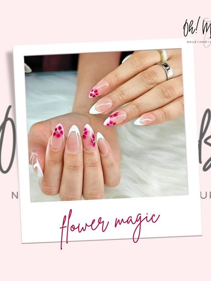 A fresh take on the French manicure, blooming right at your fingertips. This design combines classic white tips with delicate, hand-painted pink flowers for a touch of floral magic.