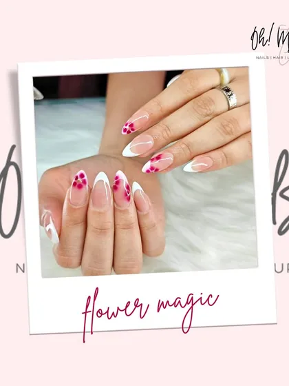 A fresh take on the French manicure, blooming right at your fingertips. This design combines classic white tips with delicate, hand-painted pink flowers for a touch of floral magic.