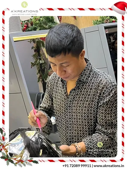 Creative Art Director Meitei carefully applies foils for a highlighting service, showcasing the meticulous technique required for beautiful, blended color.