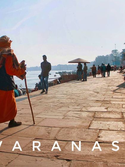 A lone figure walks along the stone path of the Varanasi ghats. This image embodies the idea of a solo journey, finding your own path along the banks of the sacred river.