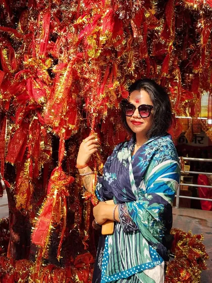 A beautiful blue printed dupatta draped gracefully for a temple visit. This shows how a single piece can define a spiritual and stylish look.