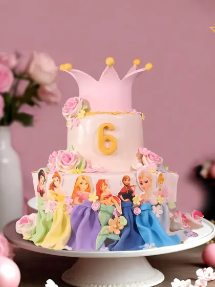This two-tier Disney Princess cake is a fairytale dream come true, featuring beloved princesses like Elsa and Rapunzel, all handcrafted with fondant and topped with a royal crown for a magical 6th birthday.
