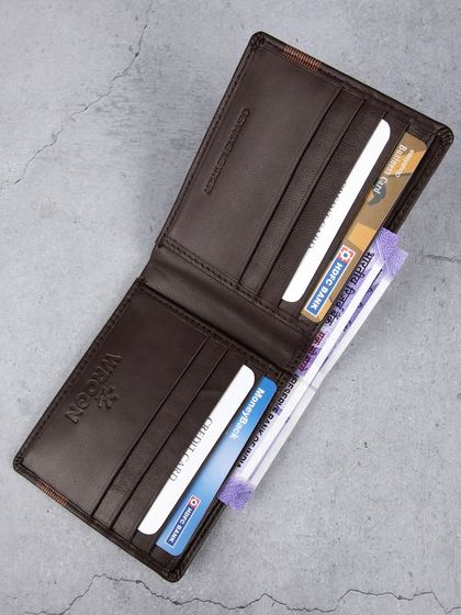 An open view of the striped 'WROGN' wallet, filled with cards and cash.