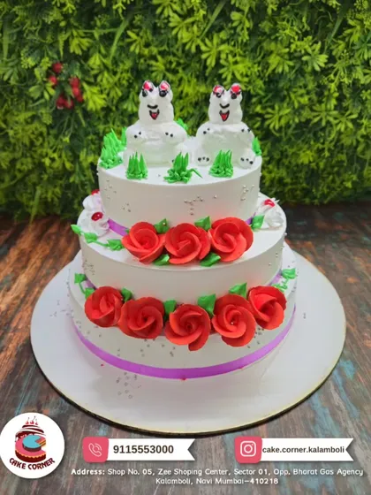 A whimsical two-tier cake with red roses and quirky frog toppers. This fun and unique design is sure to be a conversation starter at any party.