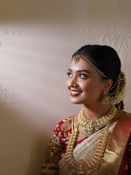 A beautifully lit portrait of the bride. The light catches the highlighter on her cheekbones, showing off the dewy, glowing finish I created.