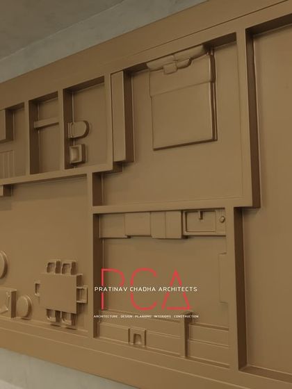 A unique piece of wall art in the StyleIn Homes office: a monochromatic, 3D architectural model of a floor plan, turning a technical drawing into a sculptural design element.