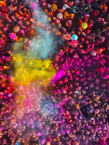 A cloud of yellow and blue gulal erupts from the crowd during Holi. These are the moments I live for, capturing the peak of the action from a perspective no one else has.
