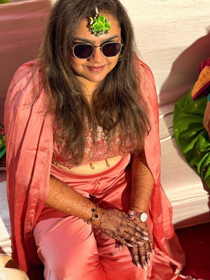 That moment of admiration after the mehendi is done. This client is checking out her fresh henna at a vibrant party.