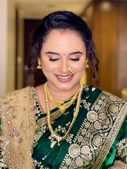 Another beautiful close-up, this time showing the soft smile and the intricate details of her traditional jewellery, all enhanced by the makeup.