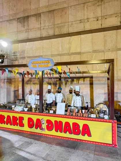 Our team of chefs at a vibrant "Kake Da Dhaba" themed counter in Amritsar. They are ready to serve up authentic, rustic Punjabi flavors with a smile.