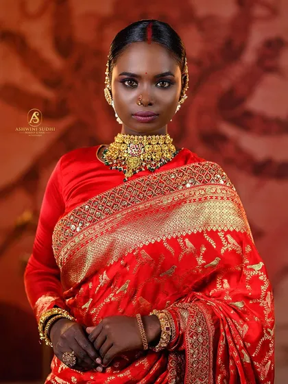 This portrait captures the strength and grace of a South Indian bridal look. I used dramatic lighting to accentuate the rich red of the saree and the intricate gold jewelry, creating a powerful image that’s perfect for a professional portfolio.