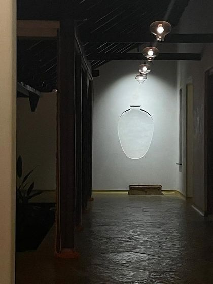 An artfully lit corridor in the Malenadu House, where a wall niche becomes a focal point.