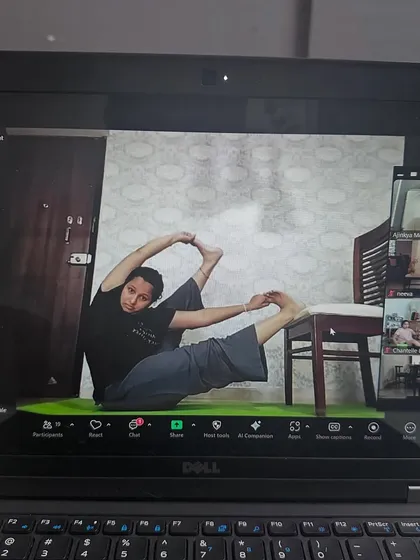 This student is using a chair at home to work on her flexibility. Our online classes are designed to give you a full studio experience, wherever you are.