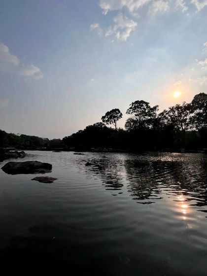 The sun setting over the river at Dubare. Even in moments of conflicting emotions, nature provides a backdrop of undeniable beauty.