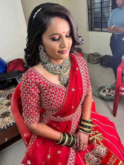 Another angle of Sanjana's reception look, showing the soft curls in her hair and the intricate details of her jewelry.