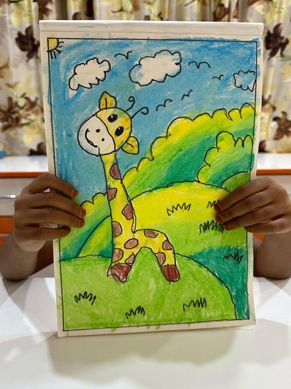This cheerful giraffe artwork shows how students learn to fill a page with colour and create a complete scene with a background and foreground.