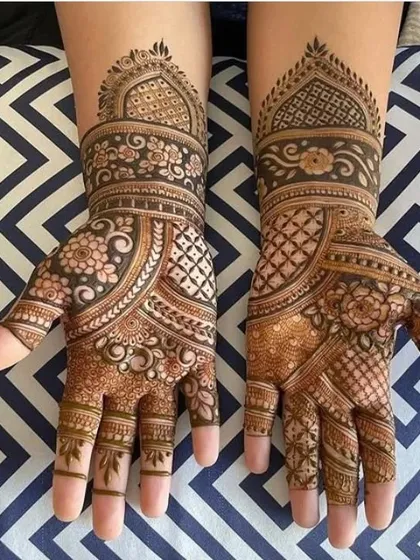 A very neat and elegant design for the hands. This pattern uses a combination of floral bands and geometric grids to create a sophisticated and traditional look.
