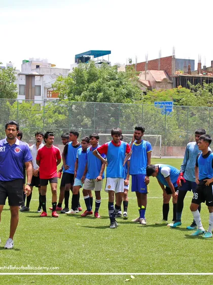 My coaching staff and I stand with a group of players during a break in the trials, outlining the next set of drills.