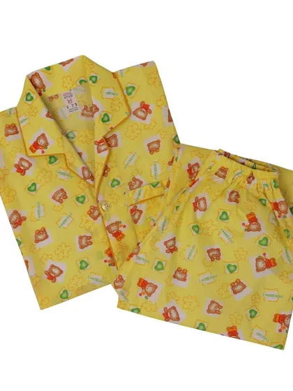 A folded yellow pajama set with a cute bear print. This angle is great for showing the product in a neat, presentable way on your online store.