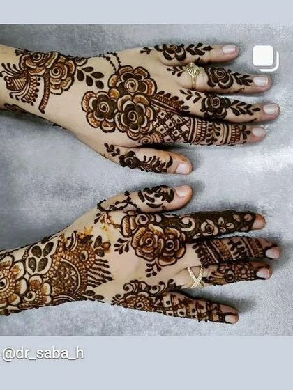 A happy client showing off her floral Arabic mehendi. The design is different on the front and back of the hand for a complete look.