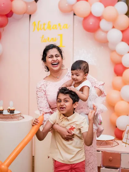 The pure, unfiltered joy of a mother and her children at a first birthday party. Our event photography is all about capturing these candid, high-energy expressions that you'll cherish forever.
