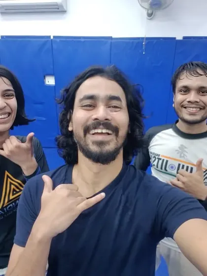 A coach and two students after a No-Gi class. The shaka sign represents the spirit of Jiu-Jitsu.