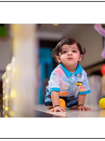 An indoor shot with great lighting that feels as natural as the outdoors. This little one is captured mid-crawl, a milestone worth remembering.