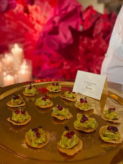 Our Avocado Bhel Papdi canapés being served on a golden tray at an iconic Diwali party, a perfect fusion appetizer for any celebration.