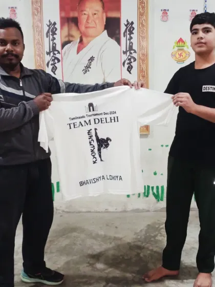 Bhavishya Lohiya gets his team t-shirt. It's a proud moment for these young karatekas.