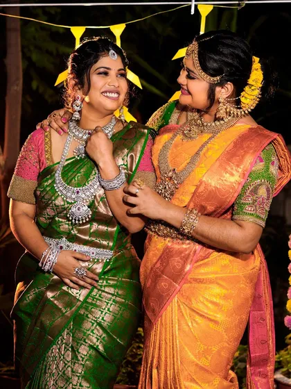 I have something for the whole bride tribe. Here you can see a bride in a traditional gold-finish set and her bridesmaid in a gorgeous American Diamond set, showing how you can coordinate styles for the whole wedding party.