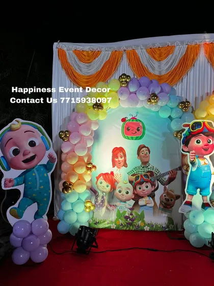 A closer view of the Cocomelon party backdrop, highlighting the main characters JJ and his family.