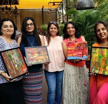A group of friends celebrating their creativity together. These women turned their regular get-together into a paint party and created these wonderful abstract pieces. Art is a fantastic way to make any social gathering more memorable.