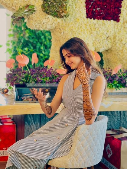 A candid shot of the client admiring her beautiful mehandi.