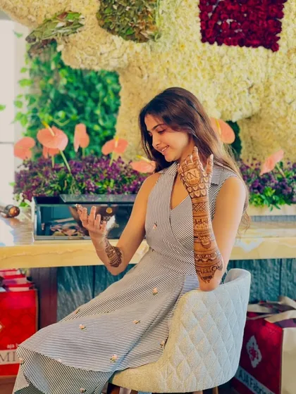 A candid shot of the client admiring her beautiful mehandi.
