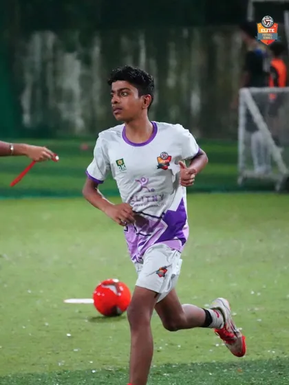 A young athlete in mid-sprint during a training exercise, building the speed needed for matchday.