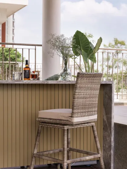 We designed this expansive outdoor bar unit for a terrace entertainment zone. It features weatherproof fluted panels and a durable marble countertop, perfect for sundowners.