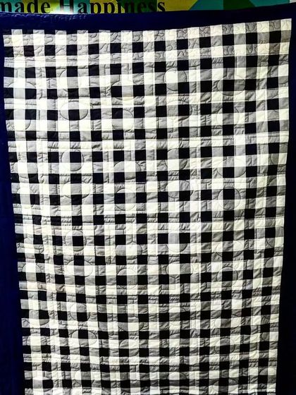 The backing for a T-shirt memory quilt, featuring a classic navy and white gingham.
