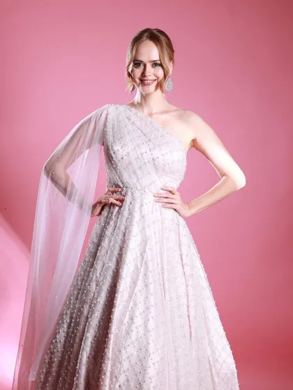 A powerful and happy pose from Irina Rudakova in her white gown, exuding confidence and joy.