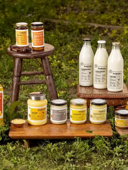 This group shot for Barosi showcases their entire farm-fresh product line in a natural, outdoor setting. It communicates the brand's core values of purity and authenticity, making it ideal for website banners and brand storytelling.