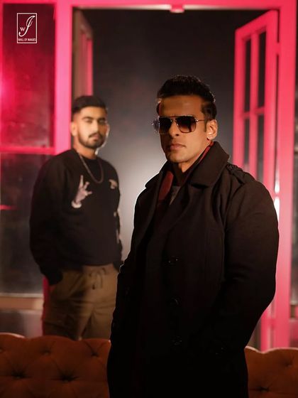 A two-person shot that tells a story. The composition, with one figure in the foreground and another in the back, creates depth and a narrative feel, perfect for promotional content.