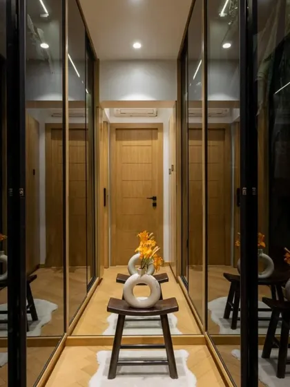 A well-designed walk-in closet maximizes both space and style. We used mirrored doors to add depth and enhance the lighting, making this narrow space feel much more spacious and luxurious.