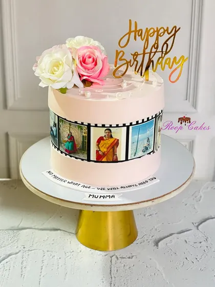 A cake that tells a story. This design for 'Mumma' features an edible photo reel of cherished memories, topped with fresh roses.